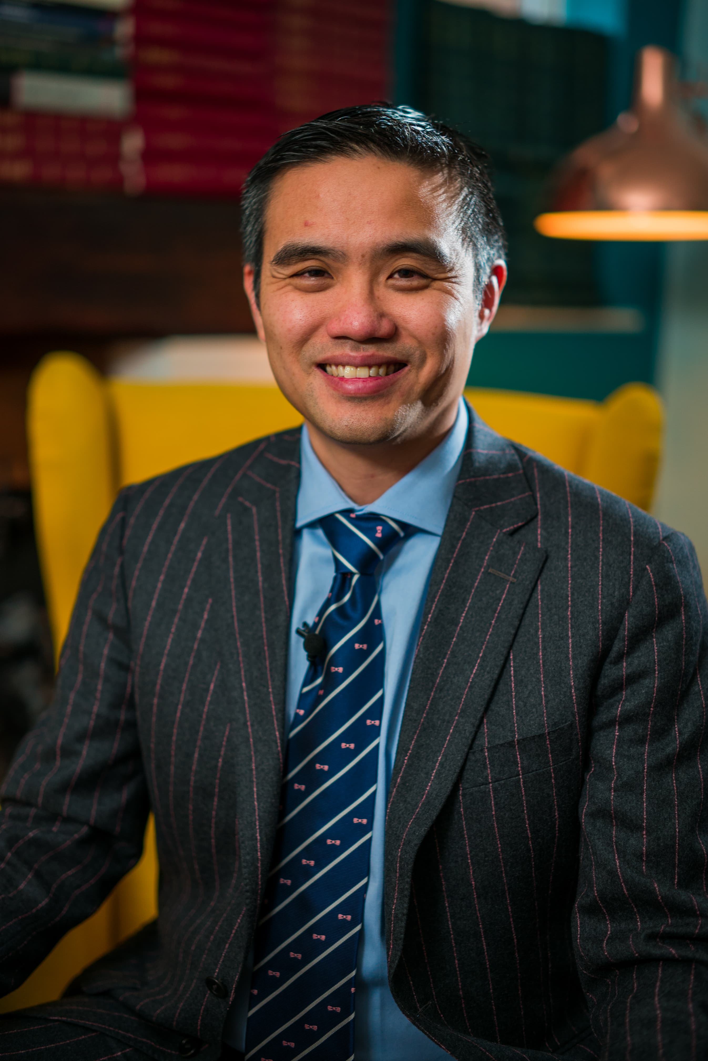 Professional smiling portrait of Professor Paul Lee wearing a suit
